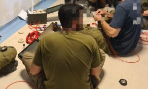 Engineering Corps soldiers preparing the explosives strings for operation using electric tape - sabotage Isolierband 