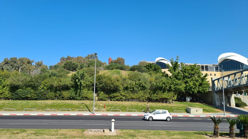 The stack pee above the trees in the middle of the pictures. Yitzhak Rabin Center building is in the right.