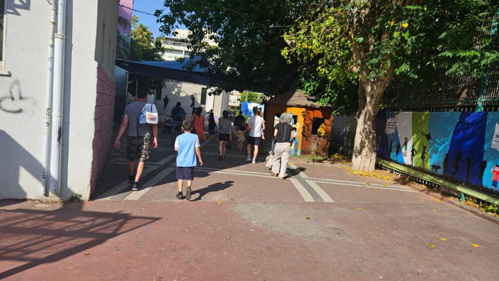 All the kids and parents taht spent Friday afternoon in playground are walking slowly towards the public shelter in the nearby school yard - pre-alert