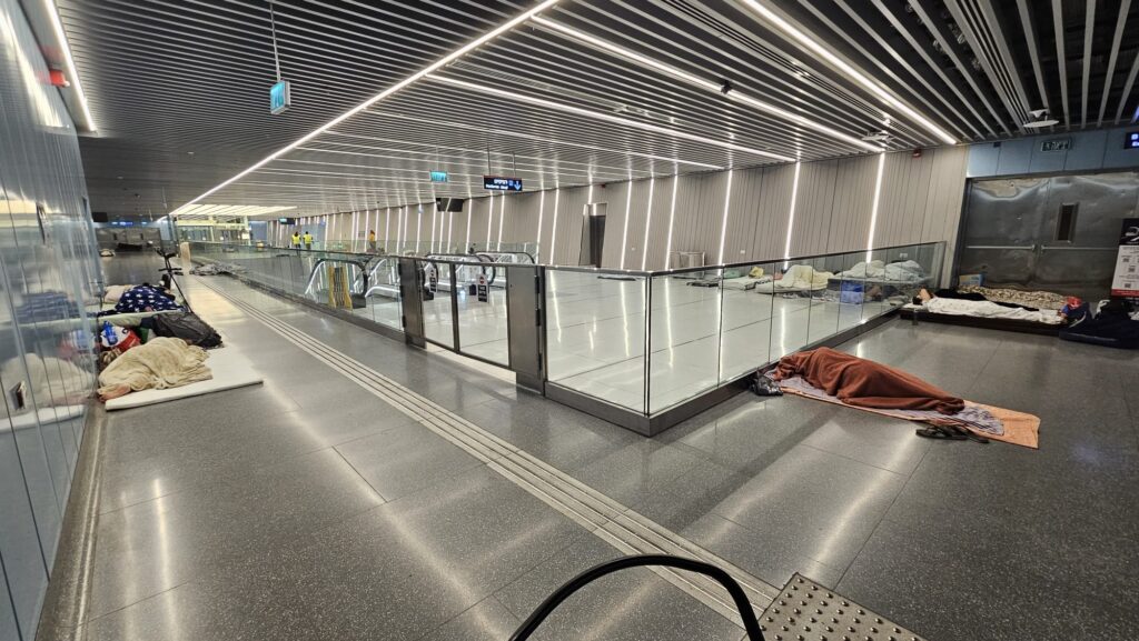 People are sleeping quietly with the lights on in the AC in the ticketing floor of the station. Where you can also find the toilets (there was a big discussions during the design and construction if toilets are necessary, as people will not stay here more than couple of minutes while waiting for the next train. Now it is clear that those toilets are needed. - shelter stations