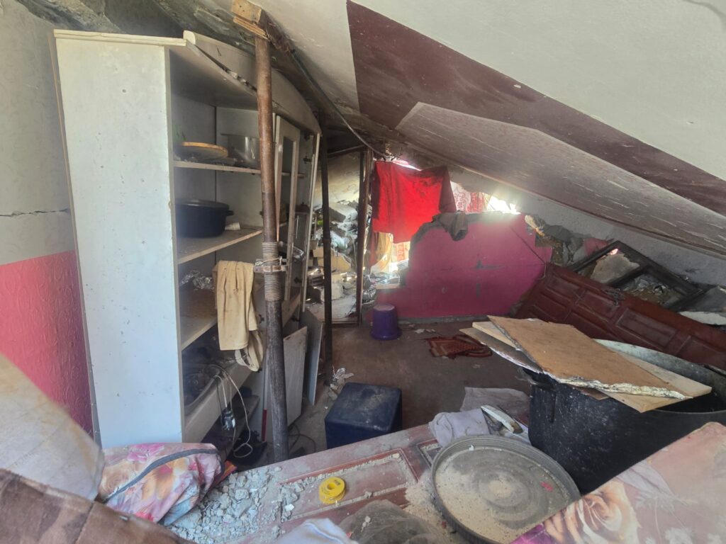 The inside of place. You can clearly observe in those ruins things that are not usually found on those places, that made the place to be marked as dangerous: from safety perspective - there are scaffolding legs that were placed to hold up the collapsed slab (they are clearly not enough) ;and from operational perspective - it is organized as some one stayed there (probably Hamas terrorist, waits to hit IDF soldiers and sneak in to the tunnels). 