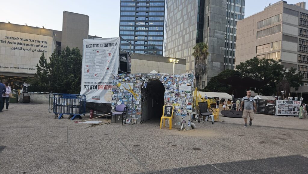 A model of a tunnel built on hostages square covered with memorial stickers, to give you the feeling of walking on those Hamas tunnels.