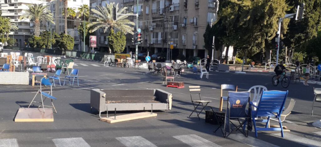 An intersection in Ramat Gan, full of furniture in the morning after Yom Kippur sitting. Might also be a scene of an Israeli swimming pool brawl with all those plastic Keter chairs all around it.