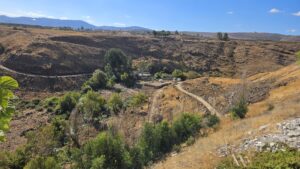 Panorama view from the walkway over the Hasbani river, the Wazzani springs and the flour mill on the stream - North part - You can see th UN post on the Wazzani springs and the road going down to it from the village