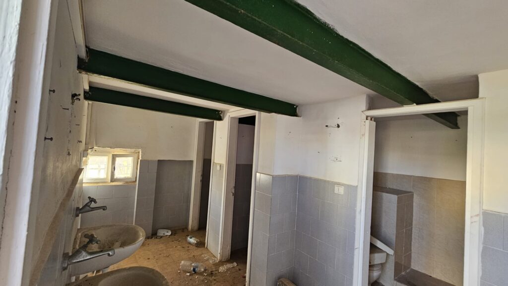 The restroom on the floor below, again with steel beams