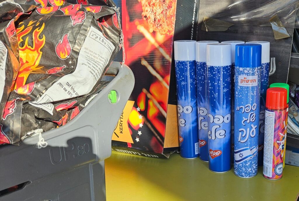 Snow and string spray sold next the charcoal for Independence day traditional BBQ (Al-Aesh) - Foam and strings spray