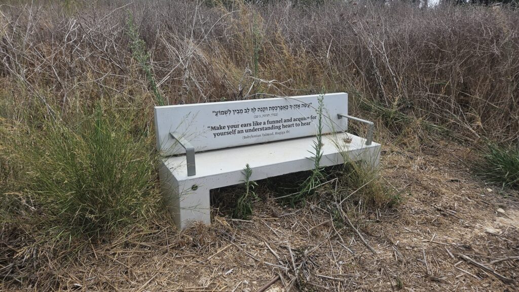 Along the less nice side of the hill, spread benches with quotes from the Talmud