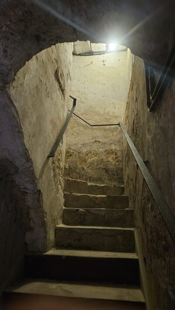 The stairs climbing up from the underground tunnel and halls